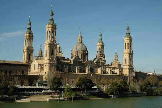 The majestic Basilica of Our Lady of the Pillar in Zaragoza, Spain, under a clear blue sky.